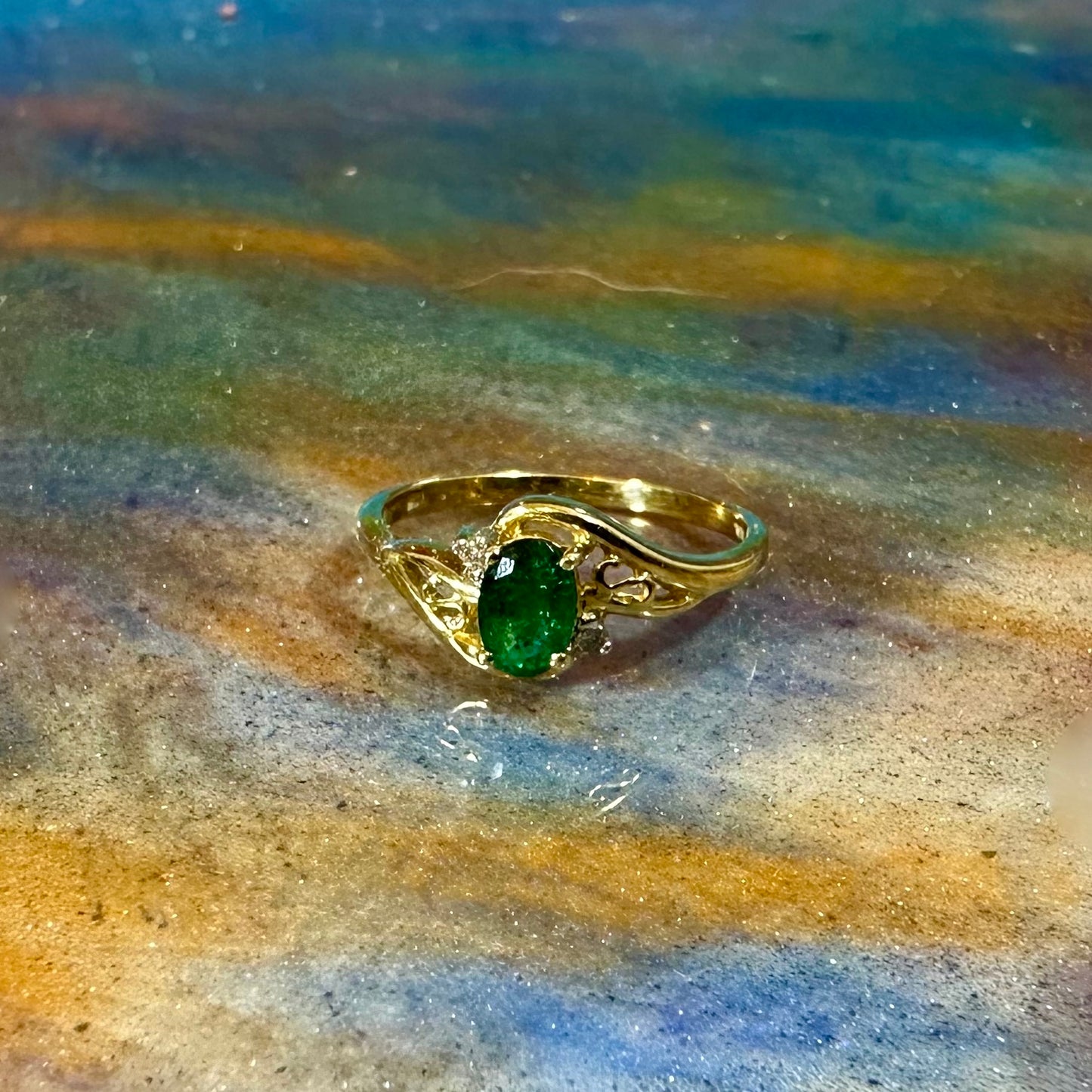 Emerald ring in 10K gold with small diamond accents