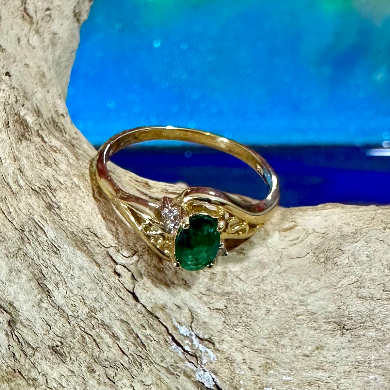 Emerald ring in 10K gold with small diamond accents