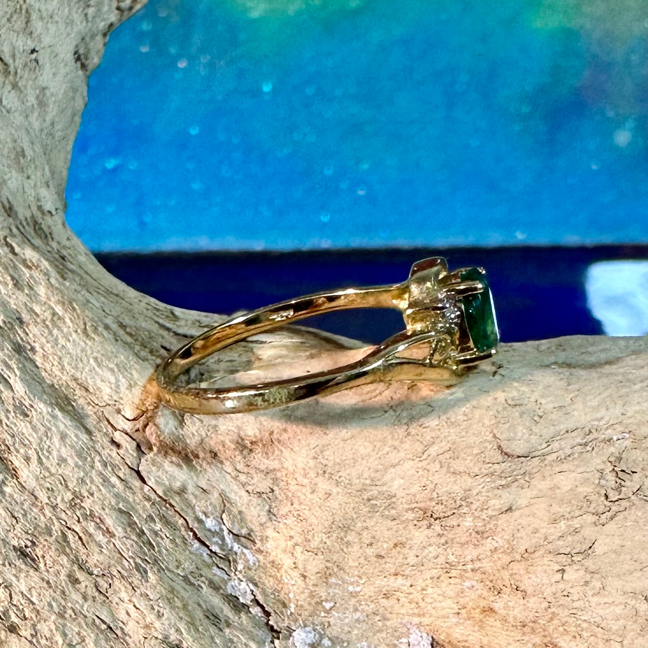 Emerald ring in 10K gold with small diamond accents