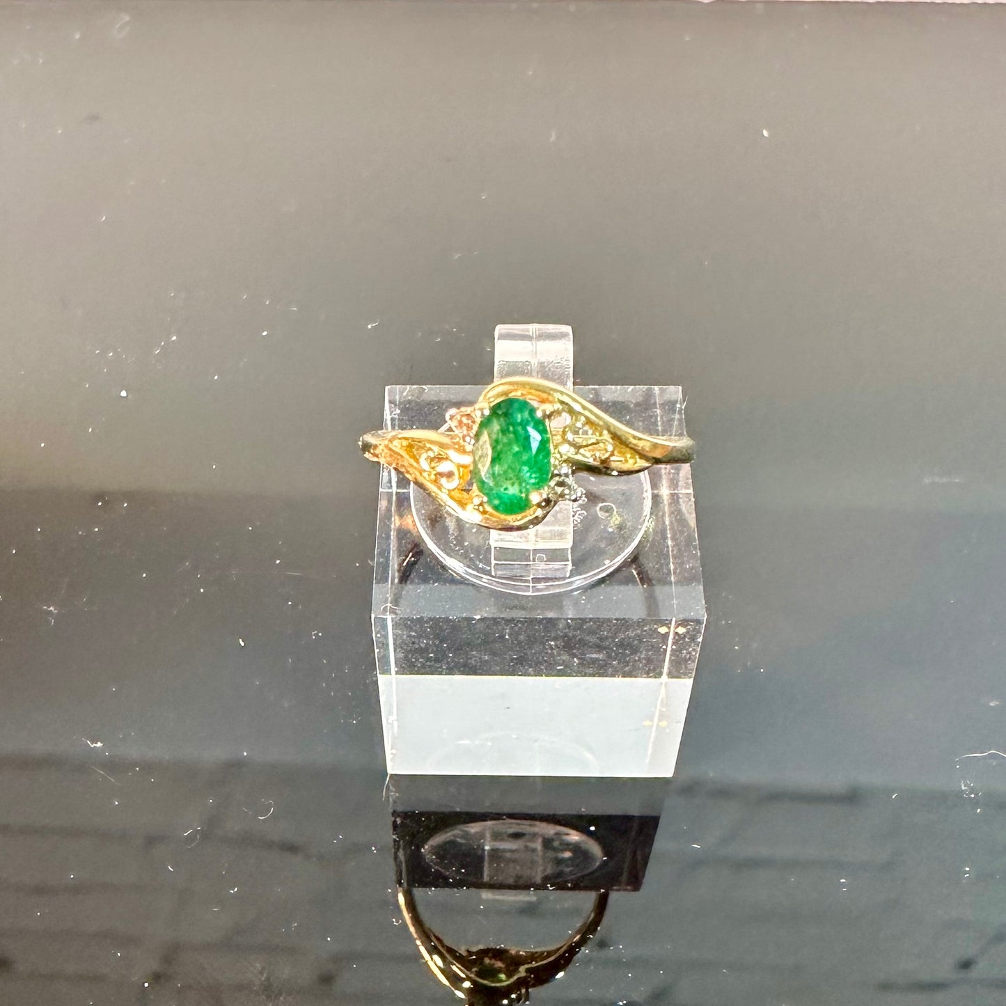 Emerald ring in 10K gold with small diamond accents