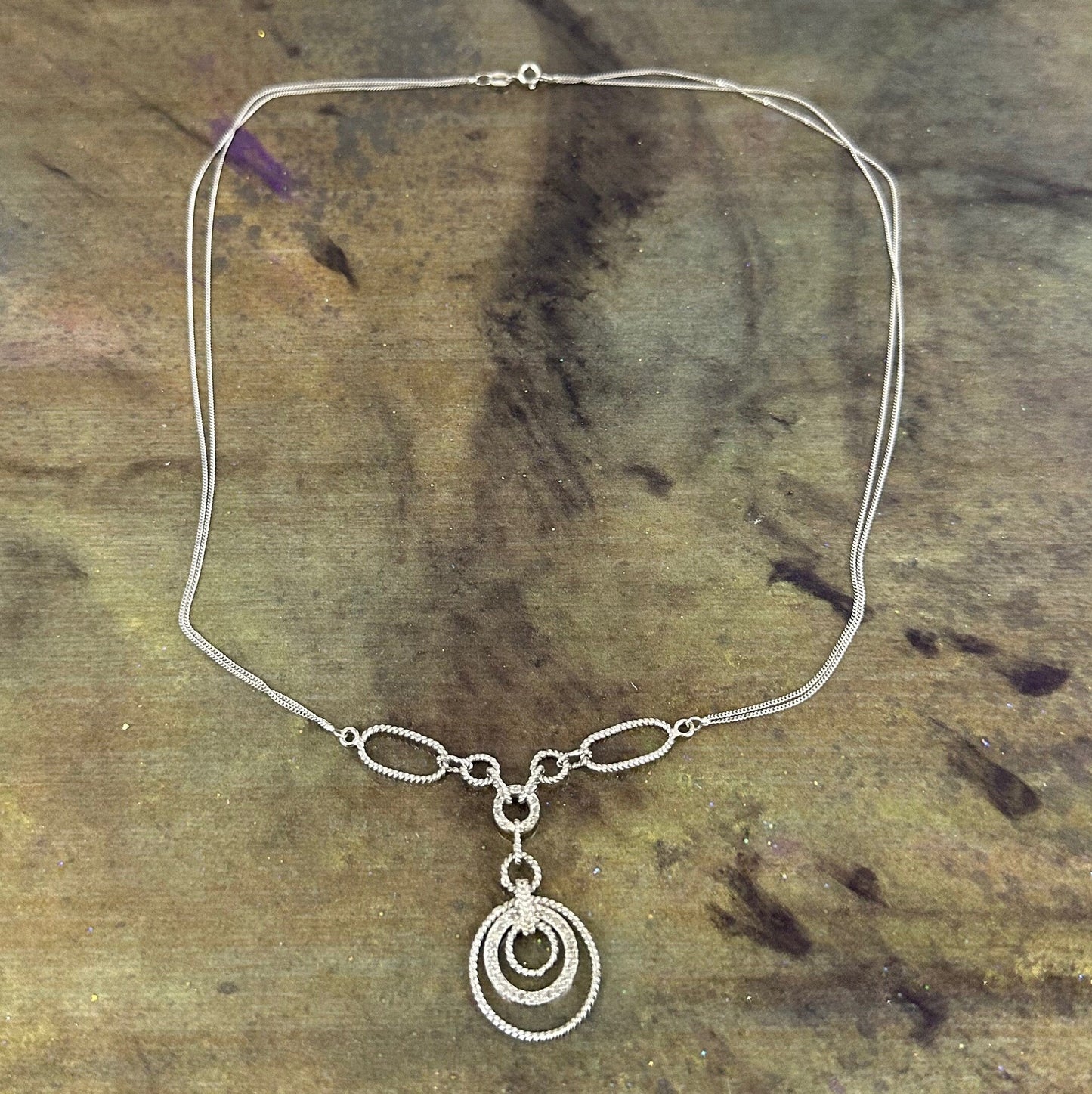 Filagree double chained necklace with diamond accents.