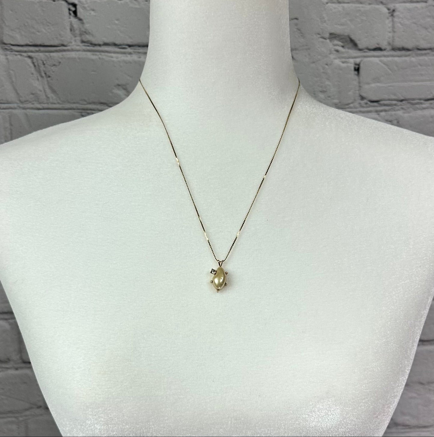 Faux pearl and Diamond pendant on Gold tone chain